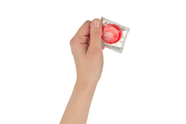Preservativo in mano donna isolato su sfondo bianco.  - Foto, immagini