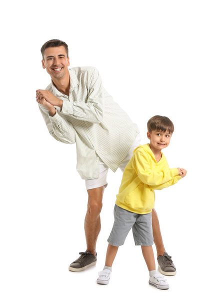 Dancing man and his little son on white background - Foto, imagen