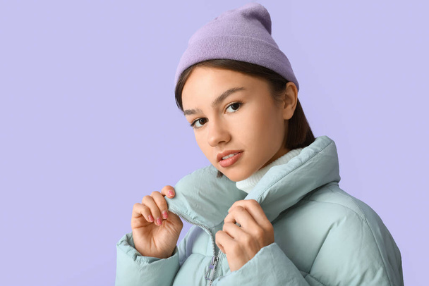 Pretty young woman in stylish warm clothes on color background - Zdjęcie, obraz