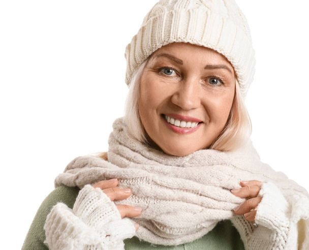 Portrait of beautiful mature woman in winter clothes on white background - Photo, Image