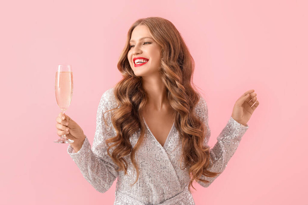 Beautiful young woman with champagne on color background - Photo, Image
