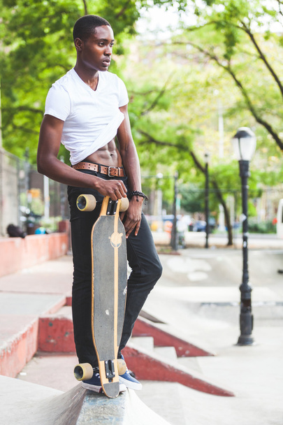Black Boy with Longboard at Park - Фото, зображення