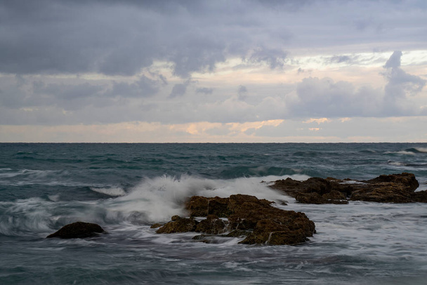 Mediterranean sea waves breaking over rocks on a stormy winter day in Israel. - Foto, Bild
