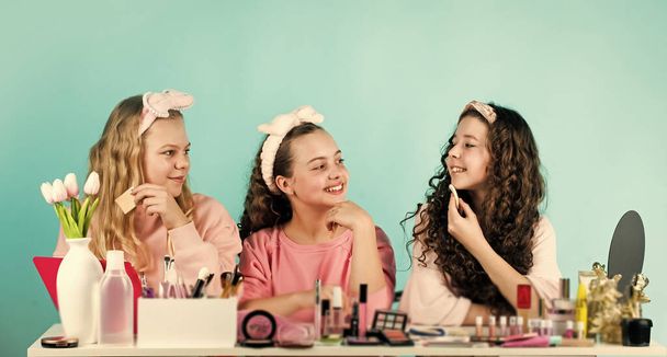 Cleanse carefully. Kids makeup. Skin care concept. Cosmetics for children. Happy womens day. Cosmetics shop. Young skin care. Beauty and fashion. Girls doing makeup together. Sisterhood happiness - Photo, image