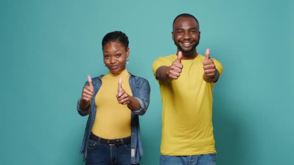Man and woman doing thumbs up and okay gesture with hands on camera - Footage, Video