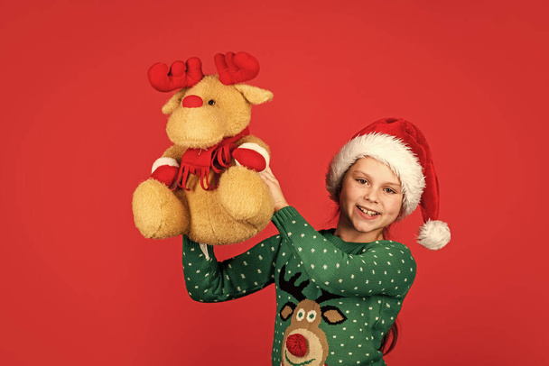 Being surprised. winter holiday mood. surprise for new year holiday. everyone will get a present. small girl santa with toy. kid with purchase. christmas shopping and sale. xmas party surprise - Fotoğraf, Görsel