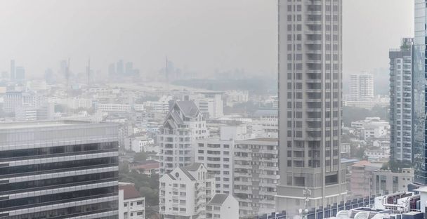 Downtown skyscrapers of the city of Bankok. Poor visibility, smog, caused by dust and smoke high level PM2.5  air pollution. - Photo, Image