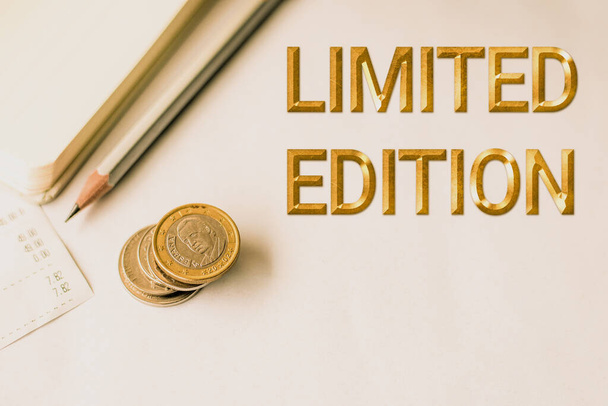 Text caption presenting Limited Edition. Word Written on Work of something which is only produced in small numbers Blank Notebook With Receipt Beside A Pencil And Stacked Euro Coins - Photo, Image