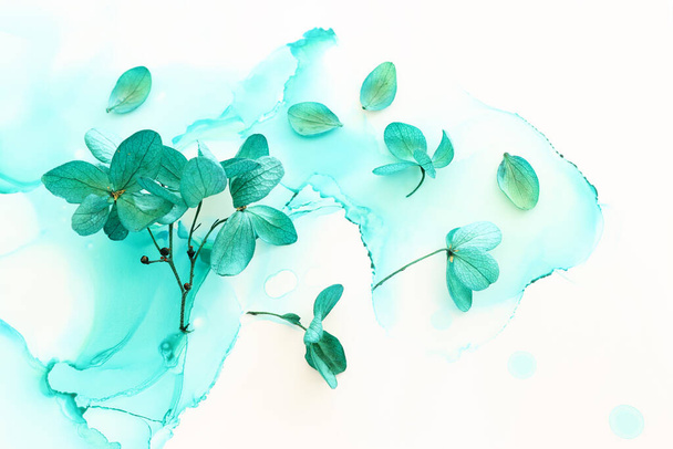 Creative image of emerald and green Hydrangea flowers on artistic ink background. Top view with copy space - Fotó, kép