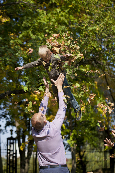 Little boy and father in autumn park - Fotó, kép