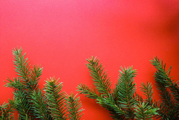 Christmas composition with gift boxes, clews of rope, paper's rools and decorations, fir tree branches on red background. Preparation for holidays. Top view with copy space, flat lay, layout, flatly. - Fotó, kép
