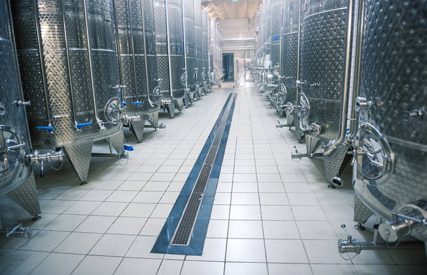 Modern winery interior, large shiny fermentation vats in perspective, selective focus - Photo, Image
