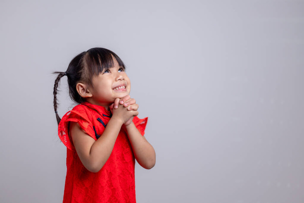 happy Chinese new year. Little Asian girls with Congratulation gesture - 写真・画像