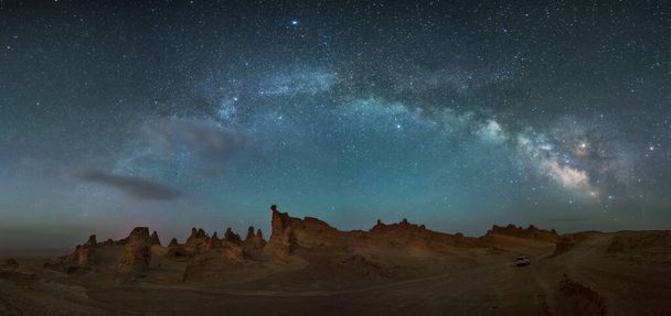 A scenic view of the rocks under the starry night sky - Fotó, kép