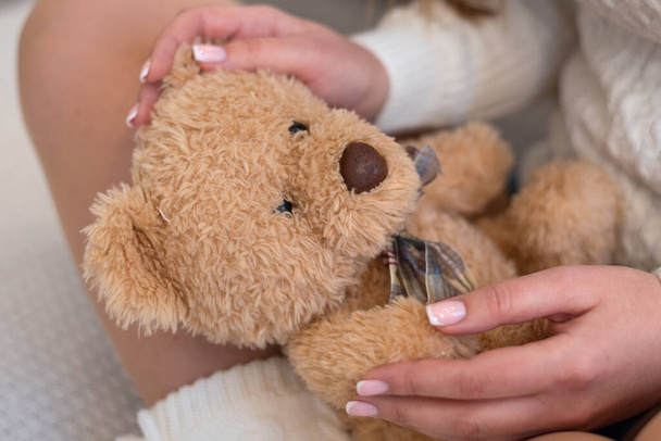 Soft toy bear in the hands of a girl - Zdjęcie, obraz