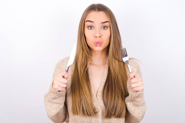 hungry woman holding fork and knife in hands - Photo, Image