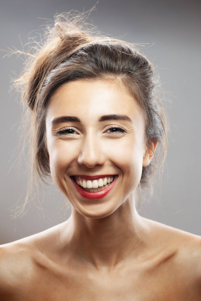 Beautiful brunette girl studio portrait. Smiling face expression. - Fotó, kép