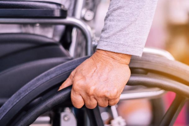 Cropped view of senior woman hands holding on wheelchair at home - Foto, immagini