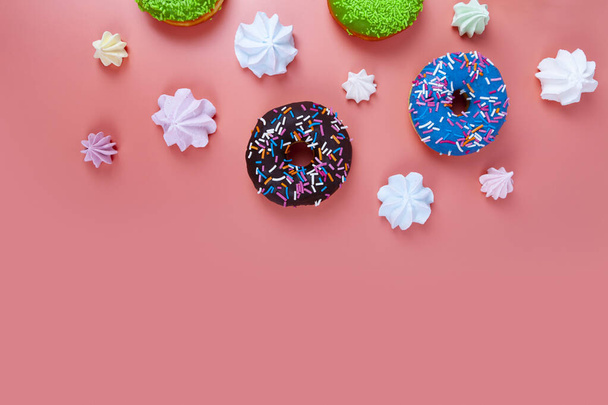 Delicious multicolored donuts and meringues on a pink background. Place for your text. - Fotografie, Obrázek