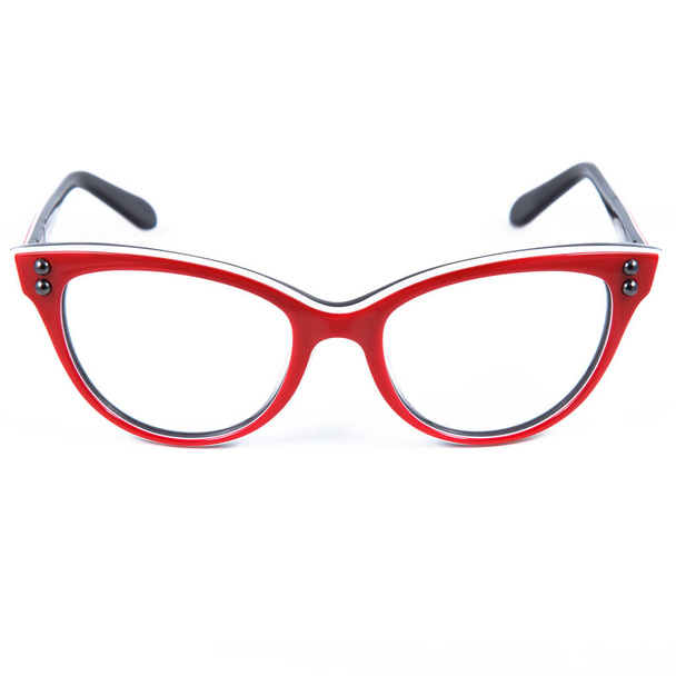 Red glasses frames on white background. Sun goggles and glasses for vision in red frames. - Photo, image