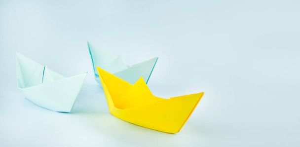 Leadership concept. Paper boats on a blue background. Business concept. Banner. Copy space. - Fotó, kép
