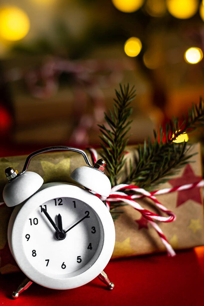 Réveillon du Nouvel An. Carte de vœux verticale heureux réveil de vacances de cinq à minuit et des cadeaux d'artisanat, bokeh, mise au point douce, gros plan. - Photo, image