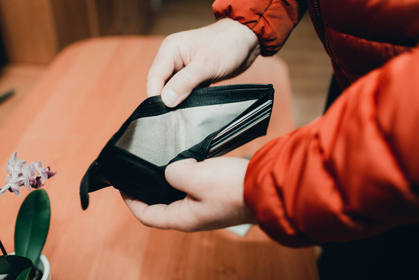 Mans hands checking wallet near desk.close up,toned.Blurred background.Soft focus. - Photo, Image