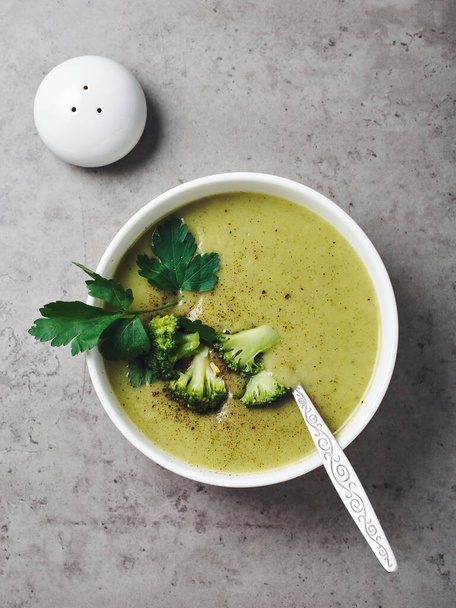 Green broccoli cream soup in a bowl, top view. - Photo, Image