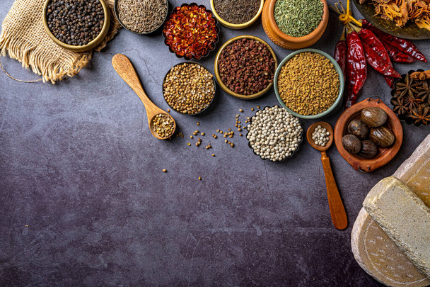 A top view of Indian seasonings and spices on a table - Fotó, kép
