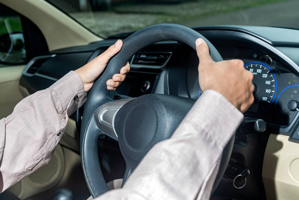 Man with his hands on the steering wheel driving a car - Φωτογραφία, εικόνα