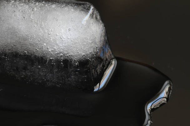 Pieces of rectangular ice on a black background. Ice cubes melt on a black background.  - Foto, Bild