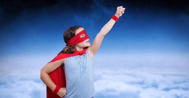 Composite image of caucasian girl in superhero costume against clouds in the blue sky. woman empowerment concept - Fotó, kép