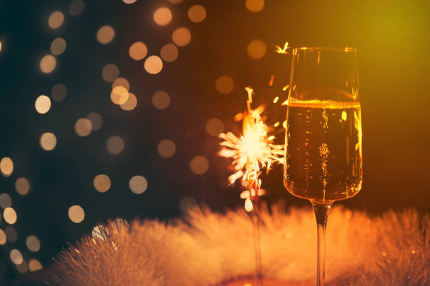 champagne glass with sparkler, festive background, vintage colors - Фото, зображення