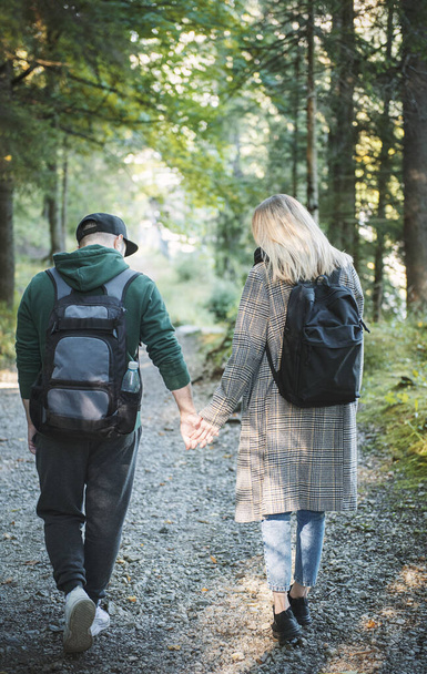 Traveler couple in love enjoying in the forest. Freedom and active lifestyle concept. Back view - Fotografie, Obrázek