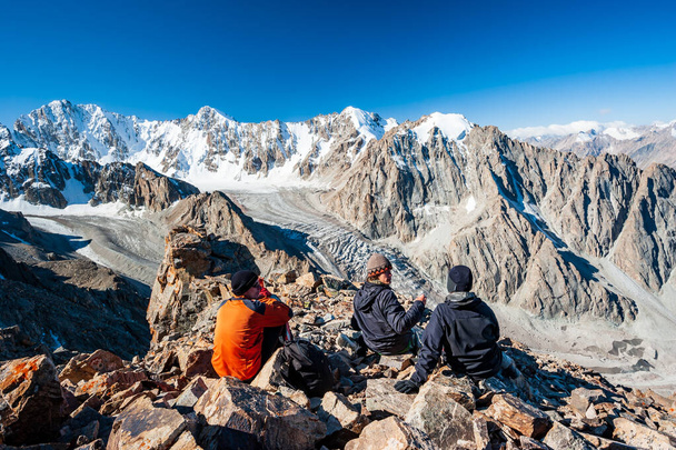 Group of trekkers climbers alpinists conquering Pik Uchitel peak from Racek Hut in Ala Archa Alpine National Park Landscape near Bishkek, Tian Shan Mountain Range, Kyrgyzstan, Central Asia. - Foto, Bild