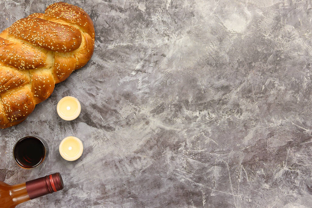 Sapatti Shalom challenge leipää, sapattiviiniä ja kynttilöitä pöydällä. Harmaa tausta. Huippunäkymä. Kopioi tila. - Valokuva, kuva