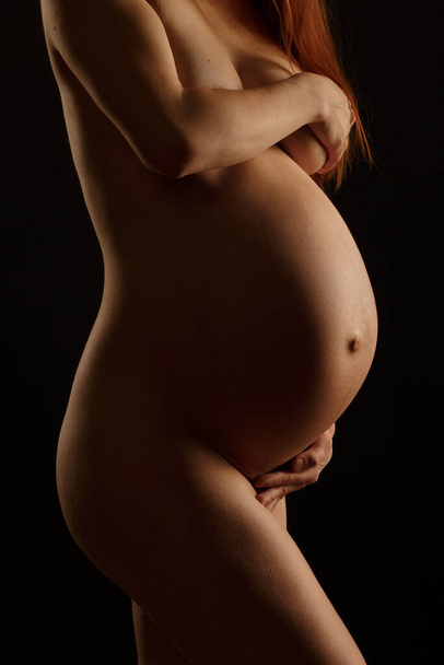 Pregnant woman, covering her brests and huge belly - Foto, Imagem