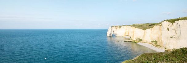 Picturesque panoramic aerial view of the Etretat white cliffs at sunset. Dramatic sky, azure water. Summer vacations in Normandy, France. Travel destinations, national landmark, sightseeing, history - Photo, Image