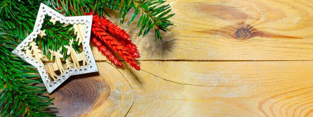 Christmas banner with fir tree branch and decorations on wooden background - 写真・画像