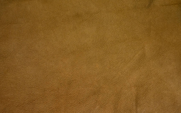 Background texture of brown genuine leather. Vintage-colored leather background. - Foto, Bild