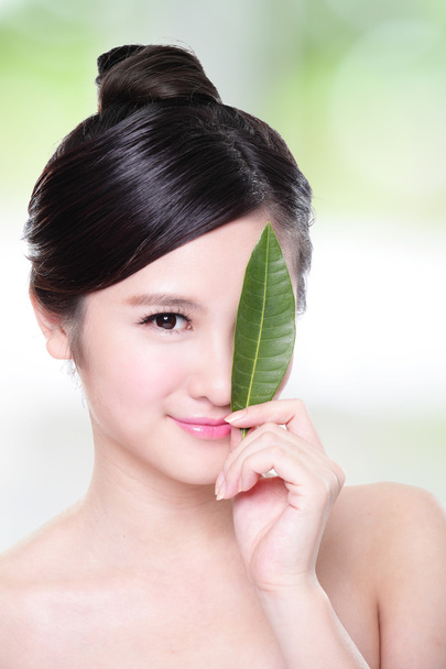 beautiful woman face portrait with green leaf - Photo, image