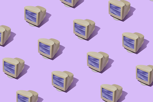 Pattern of vintage computer monitors in diagonal rows over a colorful purple background with drop shadow - Photo, Image