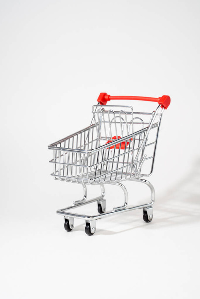 Vertical photo of a customer shopping cart on a white background - Foto, Imagem