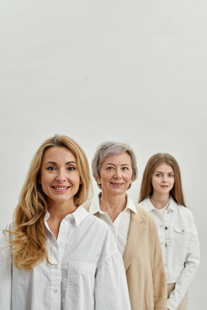 Smiling caucasian females looking at camera in row - Photo, image