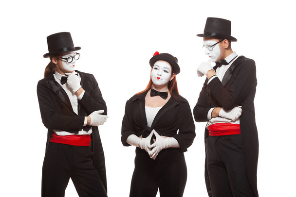 Portrait of three mime artists performing, isolated on white background. Mimes stand thinking. Symbol of finding solution, brainstorming, idea - Foto, afbeelding