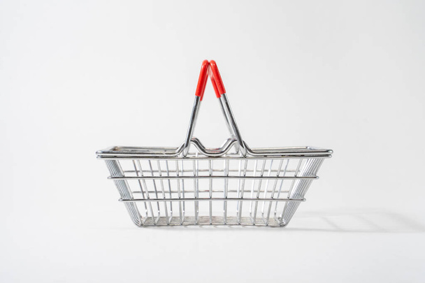 Shopping cart with raised handles on white isolated background, customer, shopper convenience - Фото, изображение