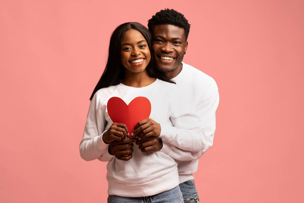 Érzelmi afro-amerikai szerelmesek pózol nagy piros szív - Fotó, kép