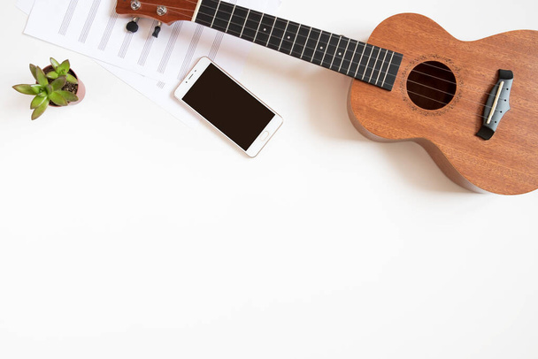 Workplace of a musician with a ukulele on a white background, top view, copy space. - Foto, immagini