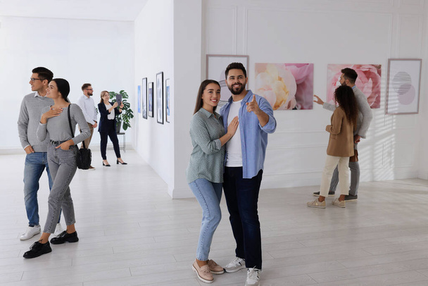 People viewing exposition in modern art gallery - 写真・画像