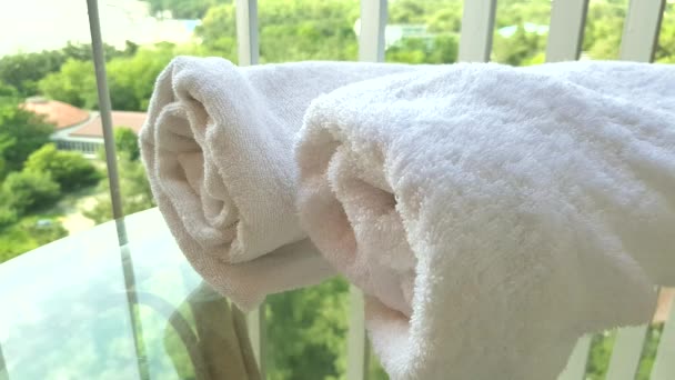 4k video, close-up of a woman's hand touching a soft white terry towel on the balcony, against the background of the sea and the park - Footage, Video